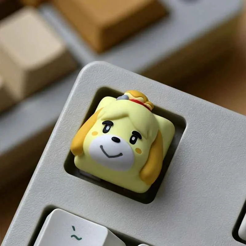 A close-up view of the charming handcrafted Animal Crossing resin keycap set, featuring detailed Tom Nook and Isabelle characters from various angles.