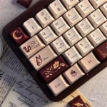 Antiquing Love Letter PBT Keycaps set. Vintage aesthetic, muted tones evoke romantic, cherished memories and aged paper look, shown from various angles.