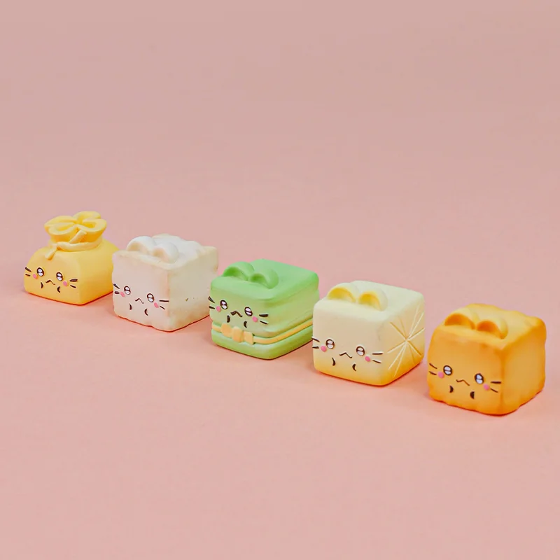 Whimsical handcrafted resin artisan keycap featuring a charming cat Oden with miniature food, captured from a unique angle to highlight its vibrant design.
