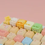 Close-up of a whimsical handcrafted resin Cat Oden artisan ESC keycap, featuring intricate miniature food art and vibrant details, perfect for feline collectors.