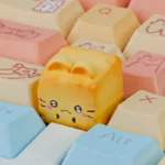 Whimsical Cat Oden resin artisan keycap, meticulously handcrafted, showcasing its adorable food theme from a charming side angle.