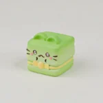 A whimsical handcrafted resin Cat Oden artisan keycap, showcased from a charming side angle, highlighting its adorable miniature food details.