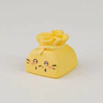 Whimsical Cat Oden resin artisan keycap depicting a playful cat holding a vibrant lucky bag filled with tiny food, a meticulously handcrafted keyboard.