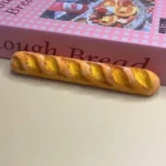 Detailed view of the whimsical baguette artisan spacebar keycap 6.25u, showcasing its unique bread-themed design and playful craftsmanship for mechanical keyboard.