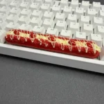 A whimsical, detailed artisan baguette spacebar keycap (6.25u) showcasing its unique bread-like texture and playful design from multiple angles.