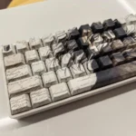Immersive Eren Yeager Attack Titan PBT keycaps set, showcasing iconic dark aesthetic and side-printed legends from a detailed perspective for a premium design.