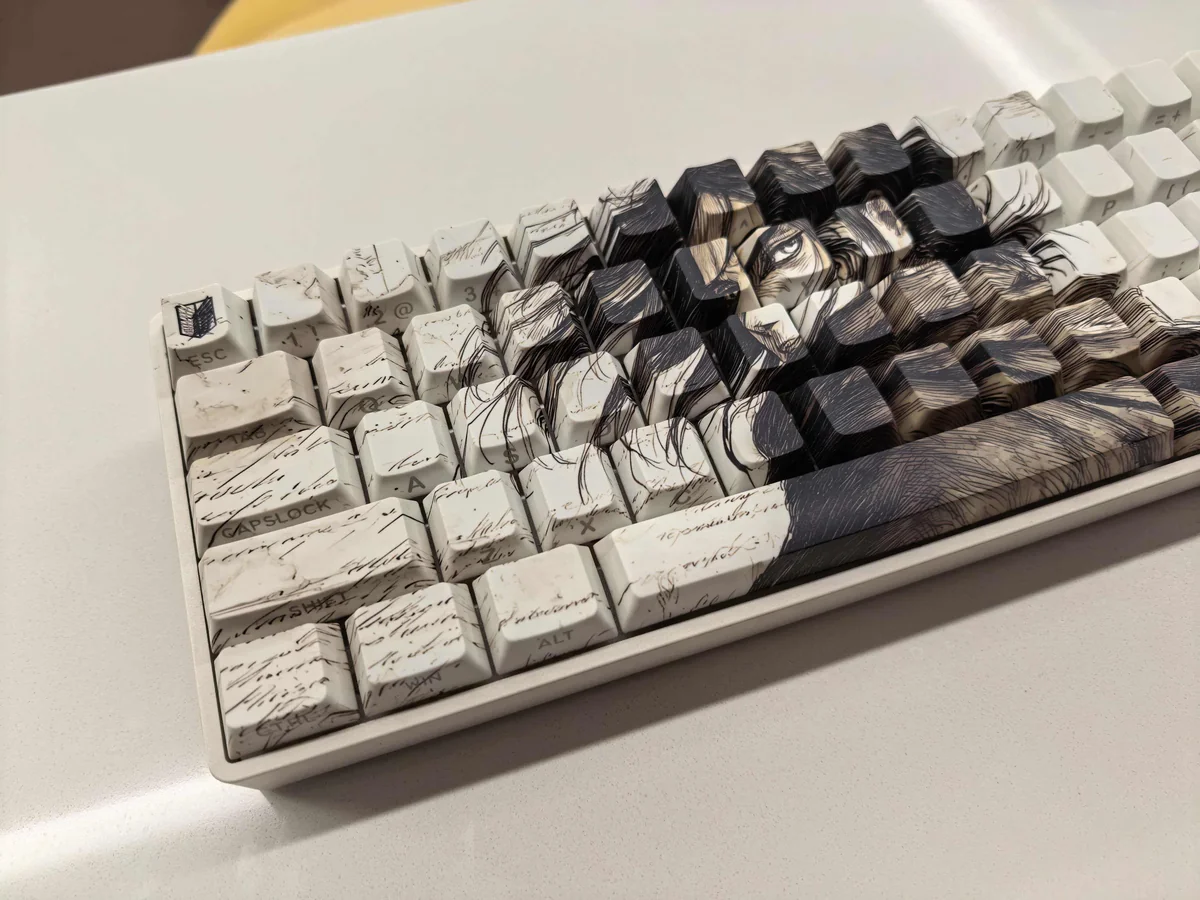 Immersive Eren Yeager Attack Titan PBT keycaps set, showcasing iconic dark aesthetic and side-printed legends from a detailed perspective for a premium design.