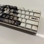 Detailed views of the premium Eren Yeager Attack Titan PBT Keycaps set, showcasing its dark aesthetic, side-printed legends, and exclusive minimalist design.