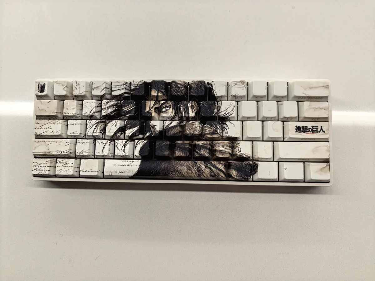 Exclusive Eren Yeager Attack Titan PBT keycaps set, highlighting the dark aesthetic, side-printed legends, and minimalist design from various premium design.