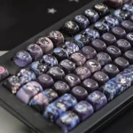 An artistic close-up of the exclusive Black Butler PBT 126-Keycap Set, showcasing intricate Gothic Victorian anime art of Ciel and Sebastian from a unique design.