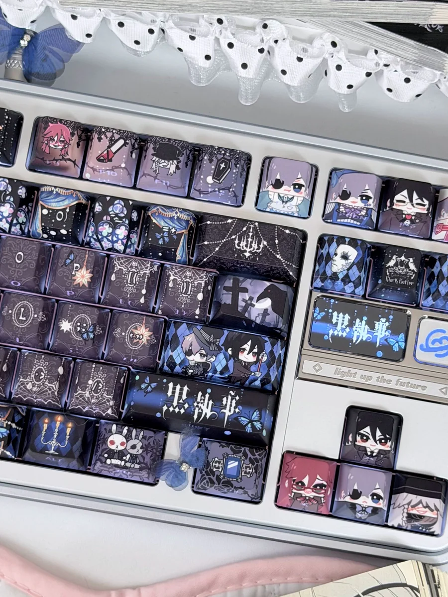 Close-up of the exclusive Black Butler PBT 126-keycap set, showcasing intricate Gothic Victorian anime art of Ciel and Sebastian from multiple angles.