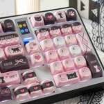Adorable Sweetheart black pink cat PBT MOA keycaps set, showcasing various angles of the whimsical dye-sub designs for a charming desktop.