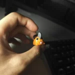 Vibrant handcrafted 3D Chainsaw Man Pochita keycap, showcasing its adorable Q-version design from various playful angles.