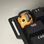 A playful, handcrafted 3D printed Q-version Chainsaw Man Pochita keycap shown from multiple angles, highlighting its vibrant detail and adorable character design.