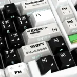 A close-up view of the Code Invasion Keycaps, showcasing the side-lit design with minimalist glowing legends against a dark, futuristic hacker design.