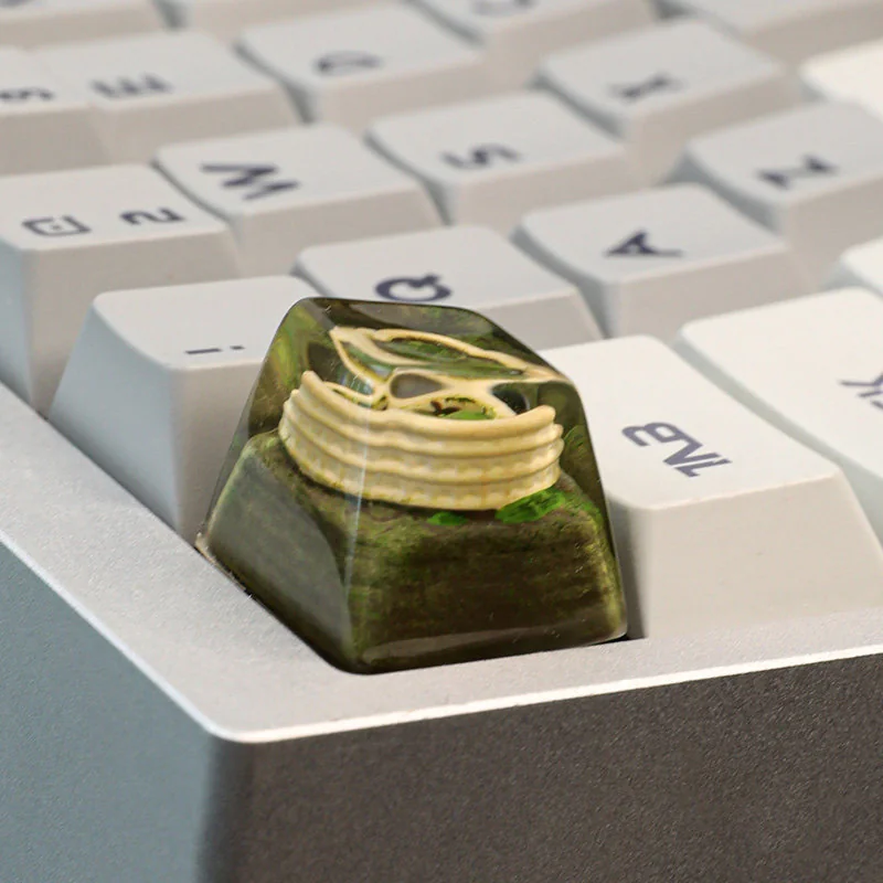 Colosseum artisan keycap shown from multiple angles, highlighting its intricate miniature Roman ruins and sculptural detail, evoking ancient grandeur design.