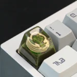 A close-up of the handcrafted resin Colosseum artisan keycap, revealing its intricate miniature sculpture of ancient Roman ruins, perfect for keyboard.