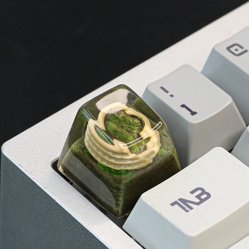 A close-up of the handcrafted resin Colosseum artisan keycap, revealing its intricate miniature sculpture of ancient Roman ruins, perfect for keyboard.