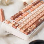 Durable PBT Dye-sublimated Cat Cafe keycaps, with whimsical cat illustrations and warm coffee palette, highlighting cozy cafe aesthetics.