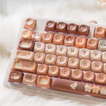 Durable PBT Dye-sublimated Cat Cafe keycaps from various angles. Whimsical cat illustrations and warm coffee colors for a cozy, artistic keyboard.