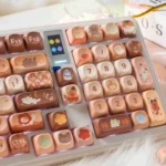 Detailed view of the durable PBT Cat Cafe keycaps, highlighting artistic cat illustrations and a cozy coffee aesthetic from a fresh perspective.