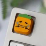 Handcrafted resin Cynical Carrot Tanaka keycap, showcasing whimsical designs. Vibrant, detailed from multiple angles, adding personality to keyboards.