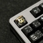 Close-up of a handcrafted artisan astronaut keycap, showcasing the intricately detailed tactical space warrior glowing within backlit resin.