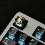 Multiple views of an intricately detailed, handcrafted resin artisan astronaut keycap, glowing with backlit brilliance in its Cherry profile.