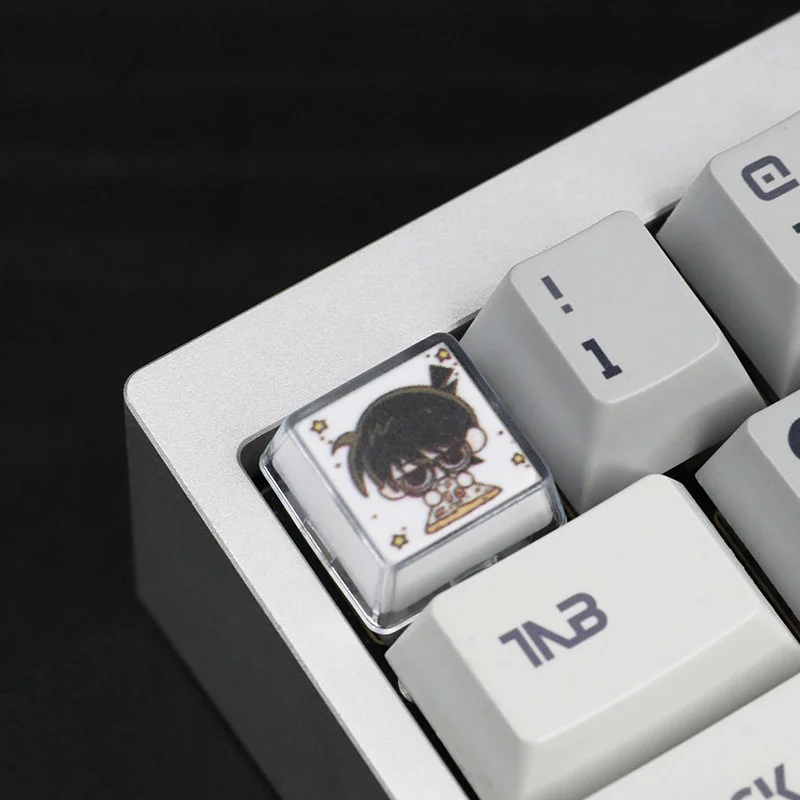 Handcrafted Detective Conan resin artisan keycap, intricately detailed with vibrant anime colors, presented from a unique artistic perspective.