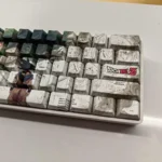 Vibrant Dragon Ball Z side-printed PBT keycaps set showcasing iconic Shenron and Goku from playful angles. This set highlights unique character legends.