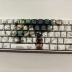Playful close-up of the Dragon Ball Z Shenron and Goku side-printed PBT keycaps set, vibrant characters from a unique angle, highlighting iconic design.
