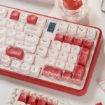 Close-up of cute red emoticon keycaps in MOA profile, showcasing playful kaomoji and heart accents. Durable PBT emoticon keycaps from various angles.