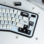 Unique Fake Angel PBT dye-sub keycaps set, from various angles, showcase whimsical, rebellious angelic designs. Soft, striking colors for an artistic look.