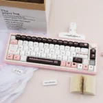 Close-up of a 'Fantasy Information' PBT dye-sub fantasy keycap set, showcasing retro-futuristic data stream patterns and vintage tech aesthetics.