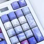 Exclusive Genshin Impact Columbina Shadowfold PBT Keycap Set. Ethereal design with mysterious shadowfold artistry, shown from various angles.