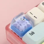 A collection of playful geometric monster keycaps for custom keyboards, showcasing unique artisan ESC designs from various angles, adding vibrant perspective.