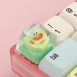 A collection of playful geometric monster keycaps, showcasing unique abstract designs from various angles, adding personalized flair to custom keyboard.