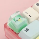 A playful gallery of unique geometric monster keycaps, featuring vibrant, abstract artisan ESC designs from various angles for custom keyboards.