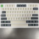 Artistic view of durable PBT GMK Coniferous R2 Cherry keycaps, revealing their intricate landscape design and earthy tones from various angles.