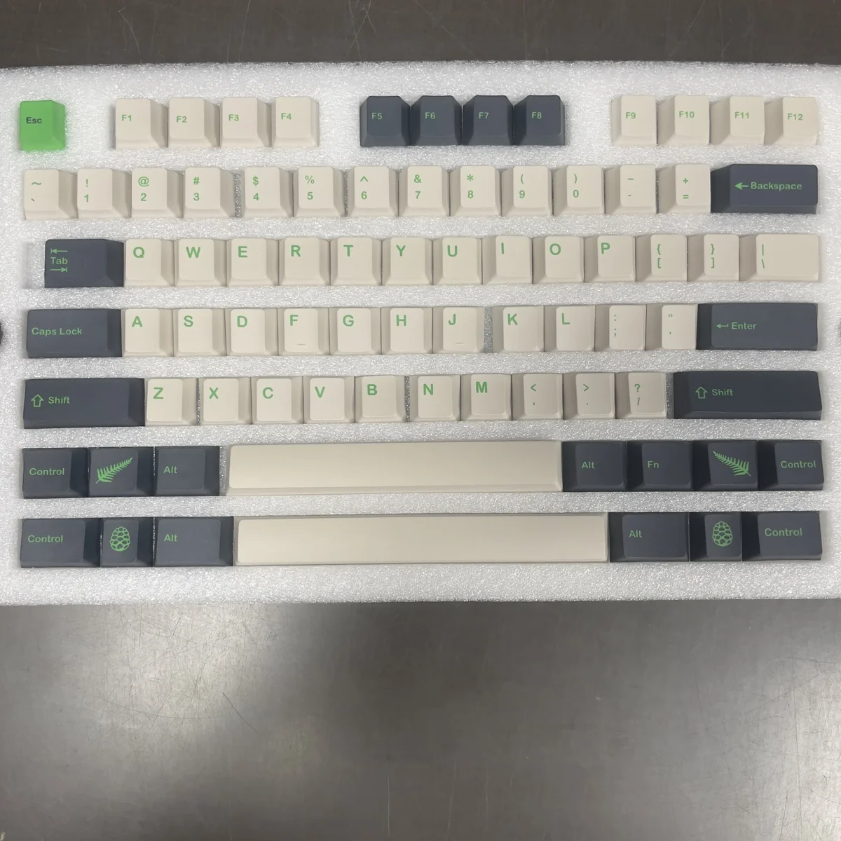 Artistic view of durable PBT GMK Coniferous R2 Cherry keycaps, revealing their intricate landscape design and earthy tones from various angles.