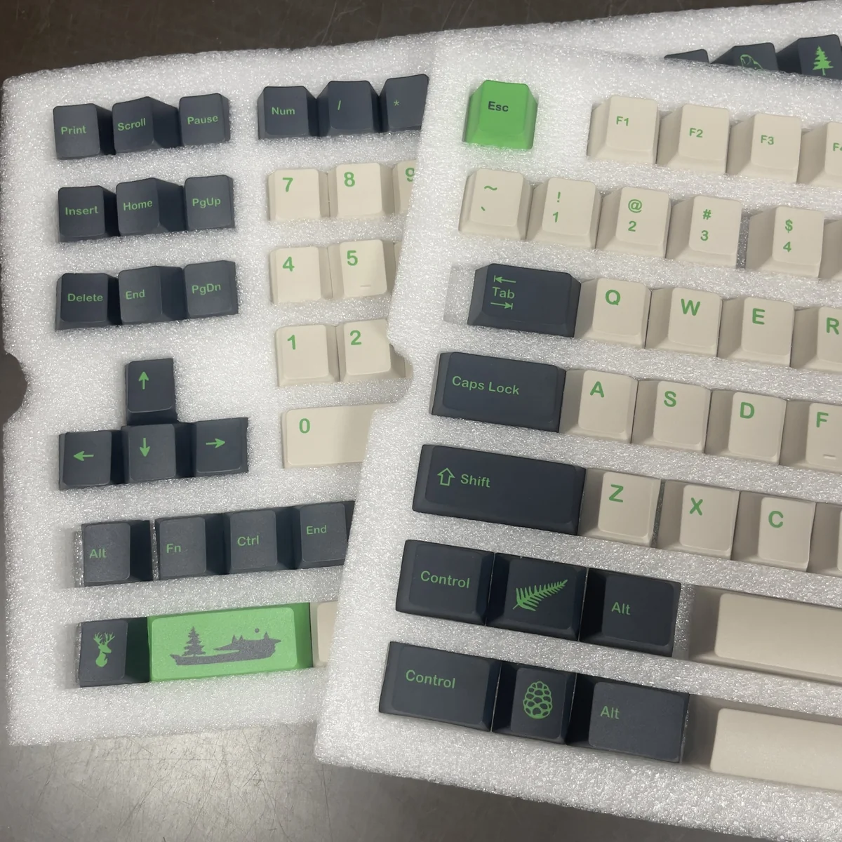 Various angles of durable PBT GMK Coniferous R2 keycaps, highlighting the artistic East Asian landscape design and calming earthy tones.