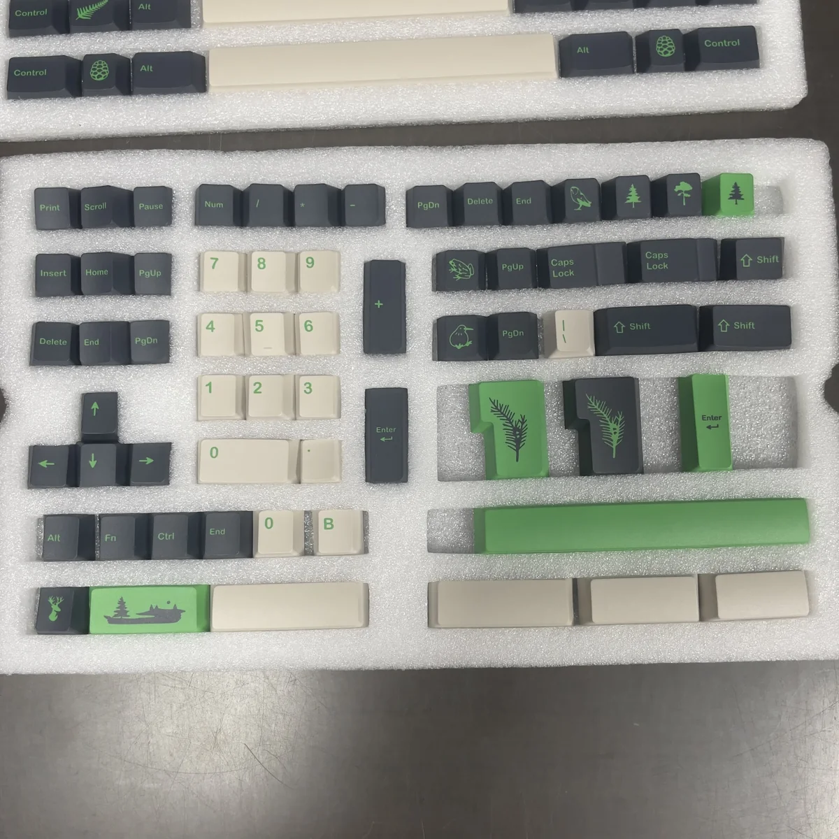 Close-up views of the GMK Coniferous R2 keycaps, showcasing the durable PBT material and intricate East Asian landscape design from various angles.