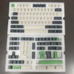 GMK Coniferous R2 Cherry Keycaps, a durable PBT Cherry set, beautifully depict a tranquil East Asian landscape in rich earthy tones.