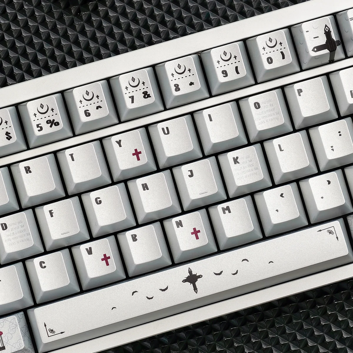 PBT dye-sub gothic style prayer keycaps. Multiple angles reveal intricate ancient sacred iconography, unique metallic sheen, and durable PBT.