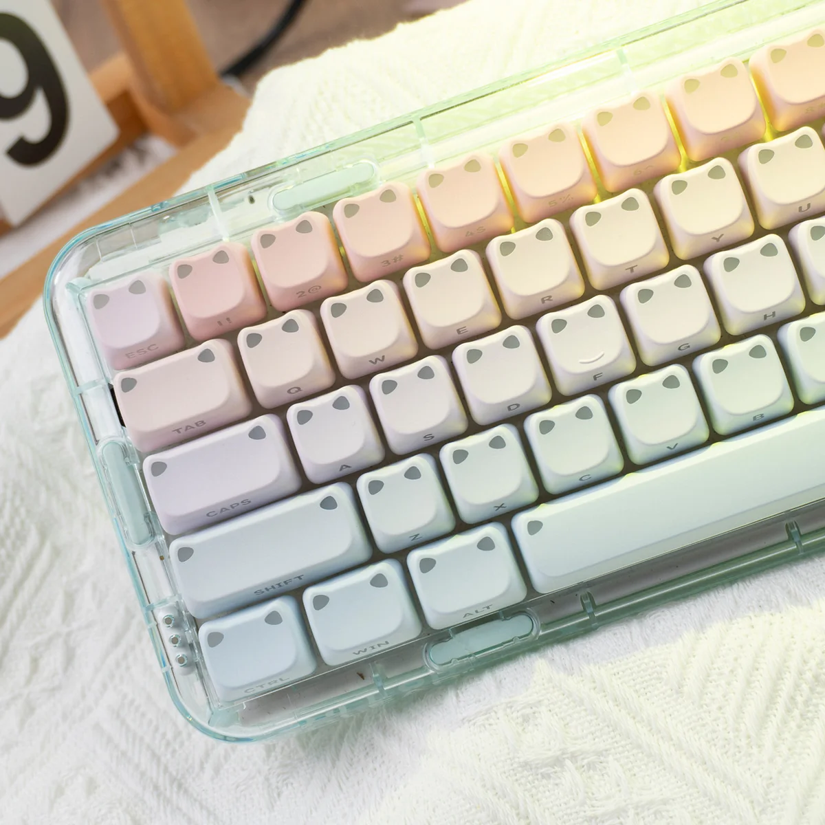 A vibrant gradient luminous cat ear keycap with side-engraved legends, adding an artistic and playful touch to any desktop.