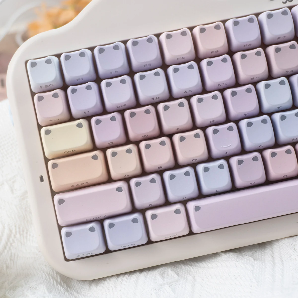 Artistic side-engraved luminous gradient cat ear keycap set, showcasing vibrant, dreamy colors and playful glowing accents for a unique setup.