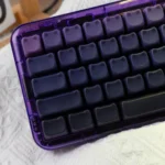 Luminous gradient cat ear keycap set with side-engraved legends, designed for a vibrant and artistic desktop.