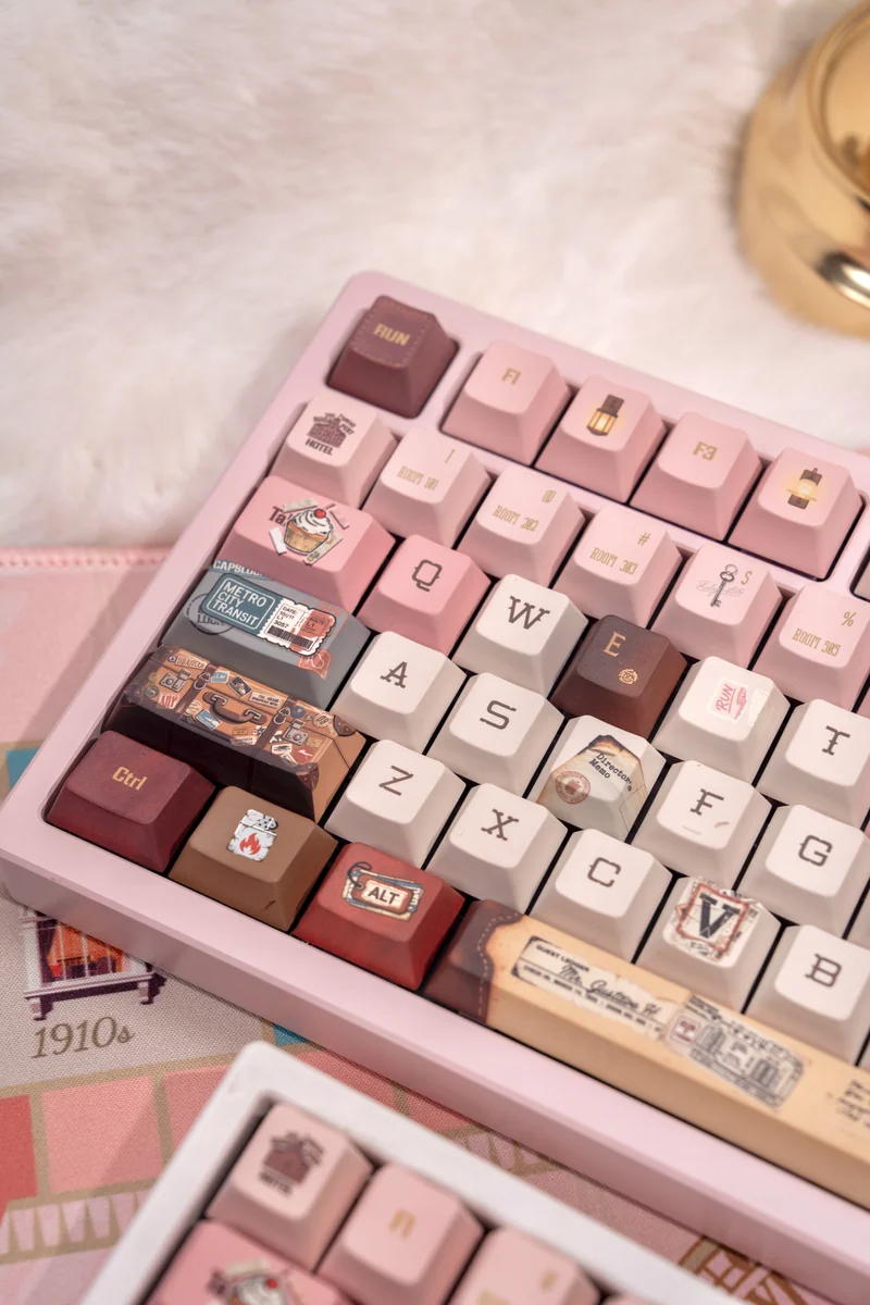 Grand Budapest Keycaps PBT set. Pastel art deco keys with Wes Anderson aesthetic. Close-up shows exclusive vintage travel theme from a unique angle.