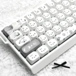 Exclusive Gray Rilakkuma PBT MOA Keycap Set shown from multiple artistic angles, featuring beloved characters in a sophisticated grayscale palette.