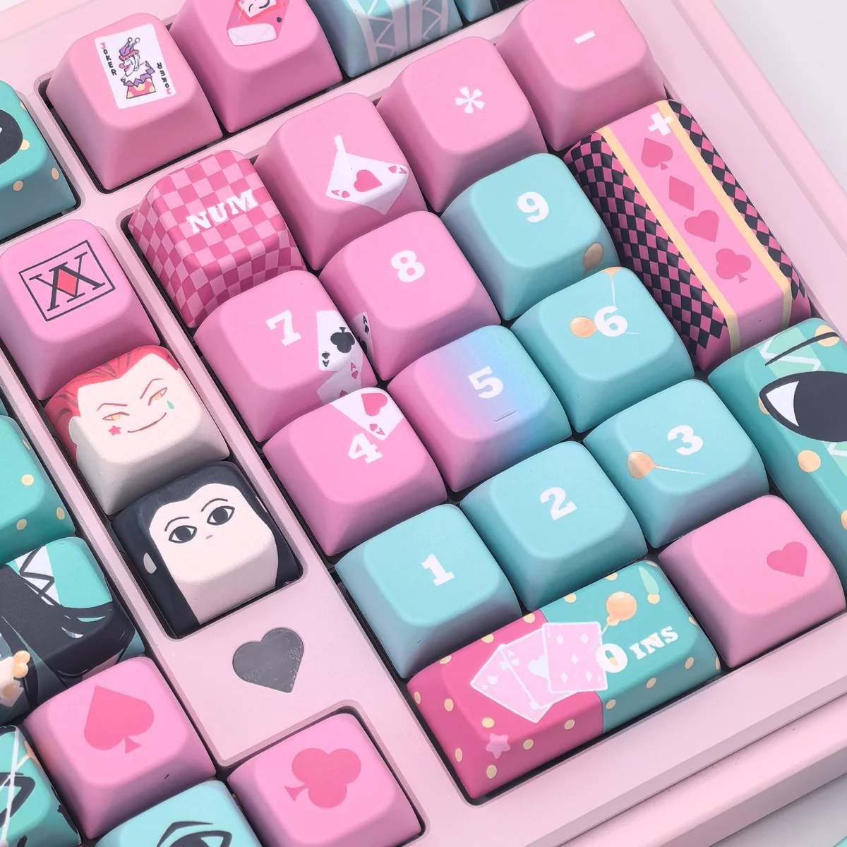 Multiple angles of the exclusive Hisoka and Illumi Zoldyck PBT MDA keycap set, showcasing its dark, mysterious Hunter x Hunter motifs and premium craftsmanship.